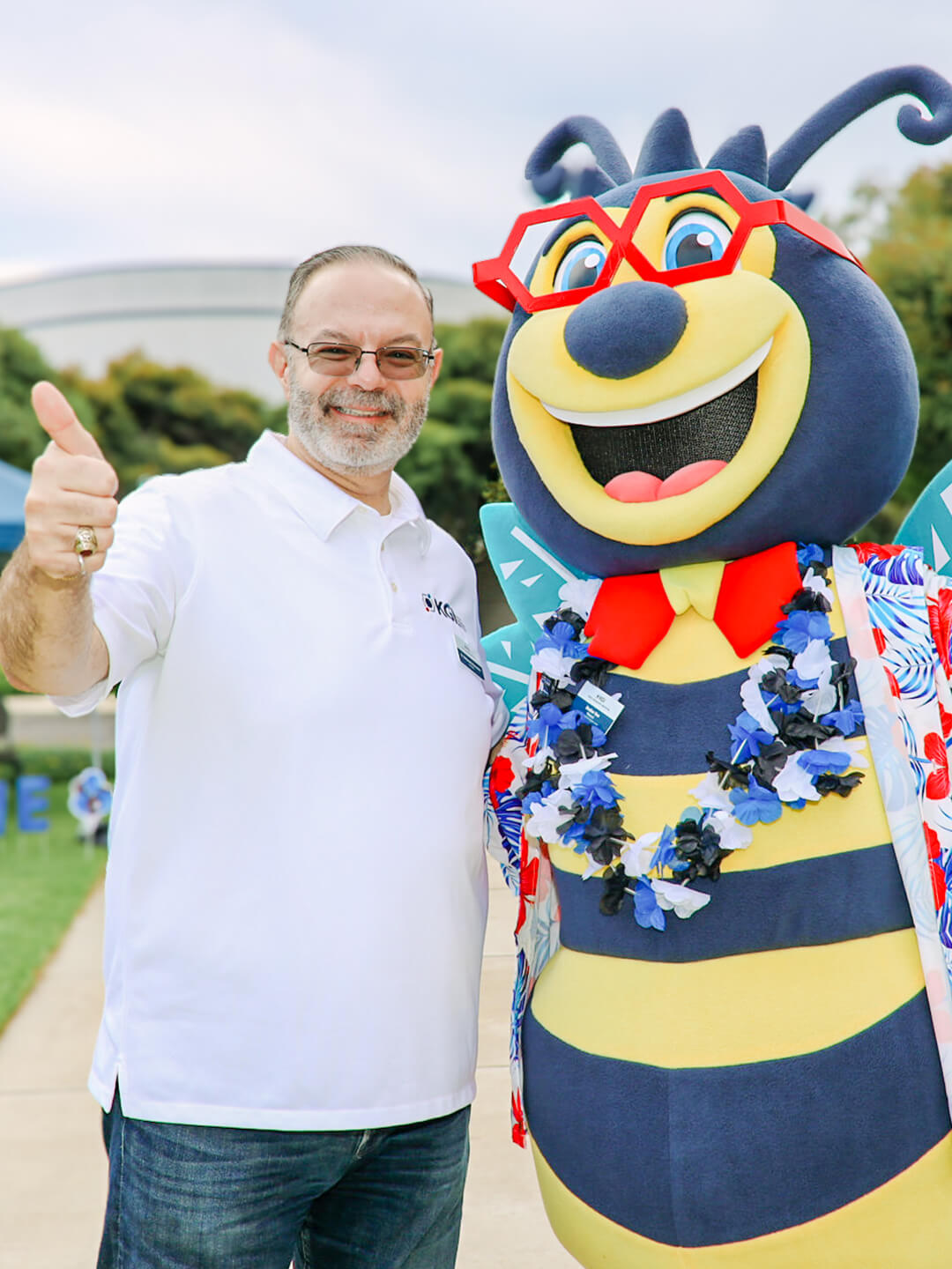 KGI president with beaker bee
