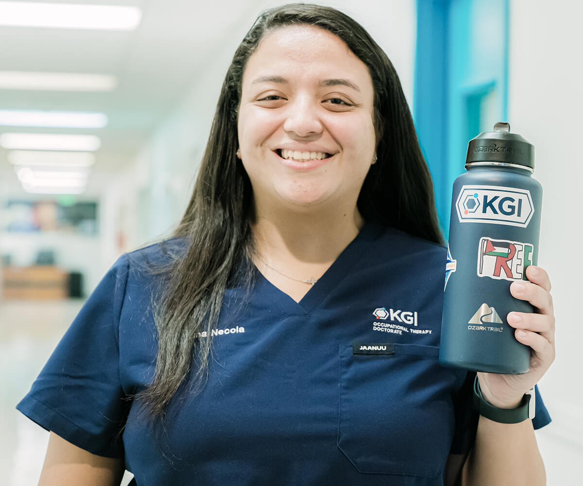 KGI female student holding a water bottle