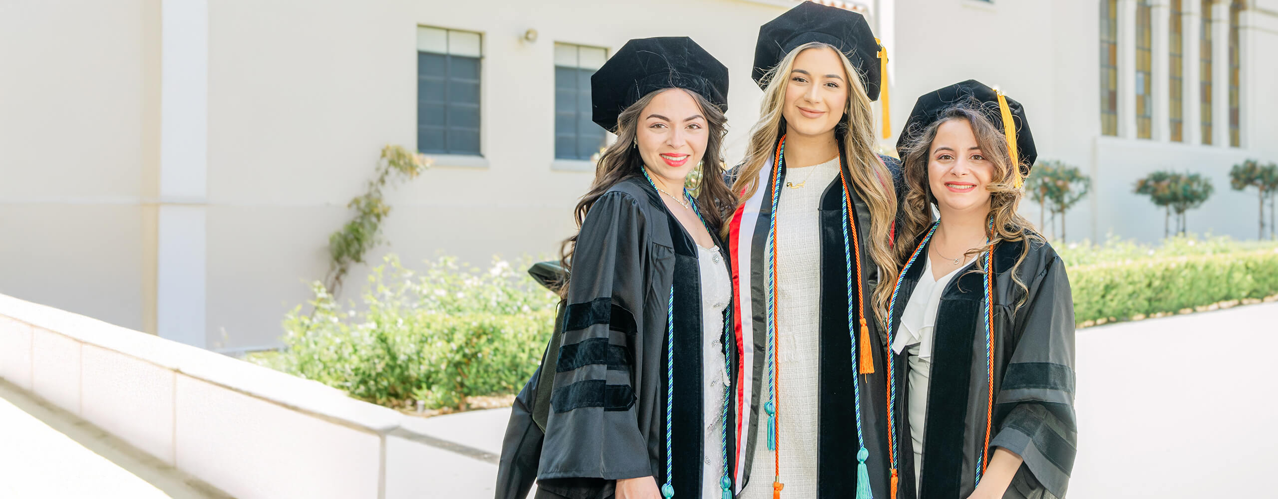 Three KGI female students at graduation
